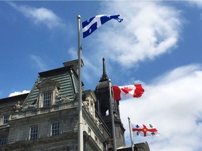 The Quebec flag flies in front of Montreal city hall, but provincial regulations say it should be in the centre.