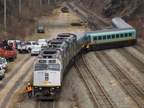 Workers examine the tracks after several VIA rail passenger cars derailed in Halifax on Sunday, Nov. 25, 2018.