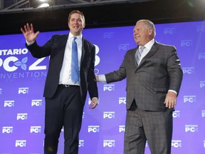 Federal Conservative leader Andrew Scheer is congratulated by Ontario Premier Doug Ford at the Ontario PC Convention 2018 held at the Toronto Congress Centre on Saturday November 17, 2018.