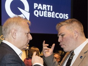 Parti Québécois interim leader Pascal Bérubé, right, talks with former leader Jean-François Lisée during a PQ meeting in Montreal on Saturday, Nov. 17, 2018.