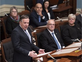 Quebec Premier Francois Legault, left, speaks during the inaugural speech, Wednesday, November 28, 2018 at the legislature in Quebec City.