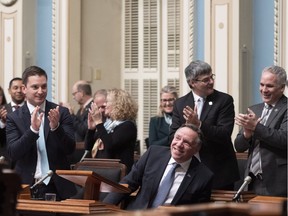 Quebec Premier Francois Legault, smiles as he is applauded by his caucus at the end of the inaugural speech, Wednesday, November 28, 2018 at the legislature in Quebec City.