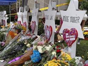 Flowers surround Stars of David on Wednesday, Oct. 31, 2018, part of a makeshift memorial outside the Tree of Life Synagogue to the 11 people killed during worship services Saturday Oct. 27, 2018 in Pittsburgh.