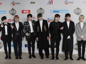 FILE - In this Dec. 2, 2016, file photo, members of South Korean K-Pop music band BTS pose for photos on the red carpet of the 2016 Mnet Asian Music Awards (MAMA) in Hong Kong. The agency for the South Korean band BTS has apologized for a member wearing a T-shirt depicting the explosion of an atomic bomb. The Big Hit Entertainment said in a statement Wednesday, Nov. 14, 2018, it was offering "our sincere apologies" for "failing to take the precautions that could have prevented the wearing of such clothing by our artist."