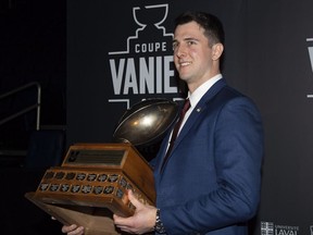 Calgary Dinos quarterback Adam Sinagra receives the Hec Crighton trophy as outstanding player of the year in Quebec City, Thursday, Nov. 22, 2018.