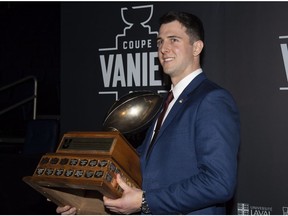 Calgary University Dinos quarterback Adam Sinagra, a Pointe-Claire native, receives the Hec Crighton trophy as outstanding player of the year, at the U SPORTS football gala as part of the Vanier Cup weekend in Quebec City, Nov. 22.
