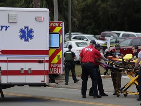 A person is transported from scene of a shooting, Friday, Nov. 2, 2018, in Tallahassee, Fla. A shooter killed two and wounded others at a yoga studio in Florida's capital before killing himself Friday, officials said.