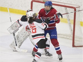 Les Canadiennes' Caroline Ouellette battles for position against the Vanke Rays' Rose Alleva during their game in Montreal Jan. 28, 2018.