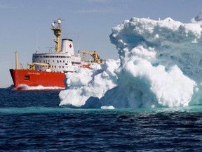 The Canadian Coast Guard icebreaker Louis S. St-Laurent sails past an iceberg in Lancaster Sound, Friday, July 11, 2008.