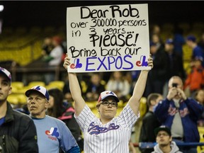 A baseball fan holds a sign asking to bring back the Montreal Expos before an exhibition game between the Toronto Blue Jays and the Boston Red Sox at the Olympic Stadium in Montreal on April 2, 2016.