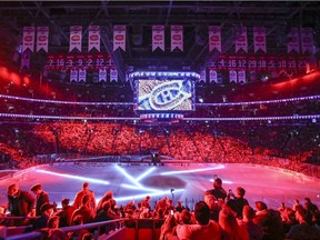 Montreal Canadiens fans take in light show prior to Game 1 of the first round of the NHL playoffs against the New York Rangers in Montreal on April 12, 2017.