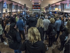 Commuters board the trains on Deux-Montagnes line at Central Station in Montreal, on Wednesday, April 25, 2018.