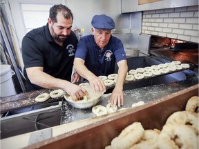 Owner Joe Morena and his son Robert prepare bagels at their St-Viateur bagel factory last year. The family says their new air purifier will save the Montreal wood-burning bagel.