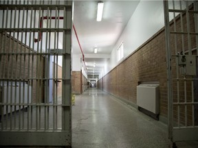 A hallway with barred gates inside a detention centre.