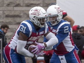Montreal Alouettes quarterback Johnny Manziel hands off to running-back William Stanback at Molson Stadium in Montreal on Oct. 8, 2018.