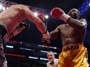 Oleksandr Gvosdyk (black trunks) punches Adonis Stevenson (gold trunks) during their WBC light heavyweight championship fight at the Videotron Centre on December 1, 2018 in Quebec City, Quebec, Canada.