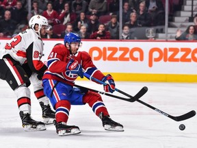 Paul Byron of the Montreal Canadiens is taken down by Christian Jaros of the Ottawa Senators at the Bell Centre on Dec. 4, 2018, in Montreal.