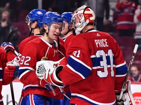 Canadiens' Jonathan Drouin celebrates a 5-2 win with goaltender Carey Price against the Ottawa Senators at the Bell Centre on Dec. 4, 2018, in Montreal.