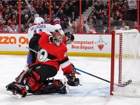 Canadiens' Brendan Gallagher celebrates his third-period goal as the puck bounces in off the leg of Senators goalie Craig Anderson while Ben Harpur watches helplessly Thursday night in Kanata.