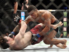 Quebecer Olivier Aubin-Mercier  fights against Gilbert Burns of Brazil in a lightweight bout during the UFC 231 event at Scotiabank Arena on Saturday, Dec. 8, 2018, in Toronto.