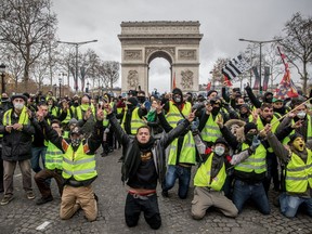 PARIS, FRANCE - DECEMBER 08: Protesters chant slogans during the 'yellow vests' demonstration on the Champs-Elysées near the Arc de Triomphe on December 8, 2018 in Paris France. ''Yellow Vests' ('Gilet Jaunes' or 'Vestes Jaunes') is a protest movement without political affiliation which was inspired by opposition to a new fuel tax. After a month of protests, which have wrecked parts of Paris and other French cities, there are fears the movement has been infiltrated by 'ultra-violent' protesters. Today's protest has involved at least 5,000 demonstrators gathering in the Parisian city centre with police having made over 200 arrests so far.