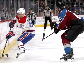 Artturi Lehkonen #62 of the Montreal Canadiens brings the puck brings the puck off the board against Nikita Zadorov #16 of the Colorado Avalanche in the first period at the Pepsi Center on December 19, 2018 in Denver, Colorado.