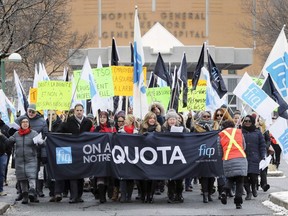 Members of the Fédération interprofessionnelle de la santé du Québec (FIQ) demonstrate outside the Lakeshore General Hospital on Thursday.