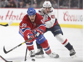 Montreal Canadiens' Andrew Shaw fights off check by Washington Capitals' Andre Burakovsky, rear, during first period in Montreal on Nov.19, 2018.