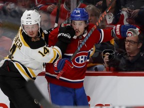 Canadiens forward Charles Hudon battles with the Boston Bruins' Chris Wagner during game at the Bell Centre in Montreal on Nov. 24, 2018.