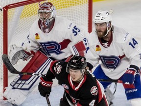 Laval Rocket goaltender Charlie Lindgren and defenceman Brett Lernout watch the play against the Belleville Senators at Place Bell in Laval on Nov. 28, 2018.