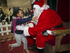 Dunmi O-Bashua runs to hug Santa Claus (a.k.a. Shane Bradford) at the Welcome Hall Mission on Saturday, December 1, 2018. Over 6,000 underprivileged families gathered in the southwest Montreal mission Saturday, many of them asylum seekers.