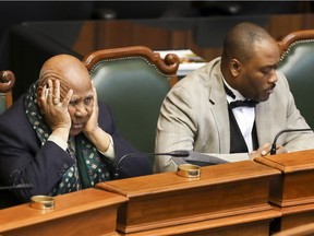 Gabriel Bazin, left, vice-president of the Black Coalition of Quebec, and lawyer Jacky-Éric Salvant listen to top members of the SPVM outline the police department's plan to tackle social and racial profiling during a special hearing by Montreal's public-security commission, at City Hall in Montreal, Tuesday, Dec. 11, 2018.