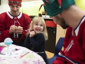 Three-year-old Francesca Chevalier is all giggles as she gets a visit from Montreal Canadiens Tomas Tatar, right, and Kenny Agostino at the Montreal Children's Hospital on Wednesday December 12, 2018.