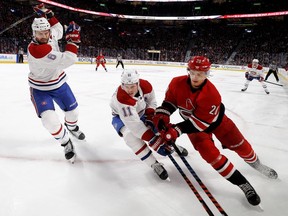 Shea Weber and Brendan Gallagher of the Canadiens corner Sebastian Aho of the Carolina Hurricanes at the Bell Centre on Thursday night.