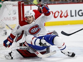 Canadiens winger Andrew Shaw crashes on to Hurricanes goaltender Petr Mrazek during action at the Bell Centre Thursday night.