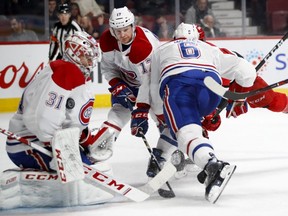 Canadiens goalie Carey Price makes a save as defencemen Brett Kulak and Shea Weber, 6, battle in front of the net Thursday night at the Bell Centre.