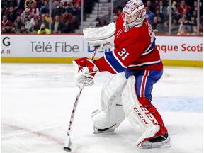 Montreal Canadiens' Carey Price passes the puck to a teammate during second period against the Boston Bruins in Montreal on Dec. 17, 2018.
