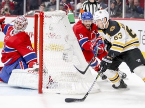 Carey Price slides across his crease as Boston Bruins'Brad Marchand tries a wrap-around shot while being pursued Shea Weber during second period  in Montreal Monday, Dec. 17, 2018.