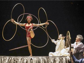 An acrobat spins hoops on Mauro's deathbed during opening night performance of Cirque du Soleil's Corteo at the Bell Centre in Montreal, Dec. 19, 2018.