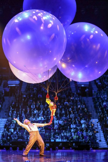 Mauro launches a little person suspended by giant balloons into the air during opening night performance of Cirque du Soleil's Corteo in Montreal Dec. 19, 2018.