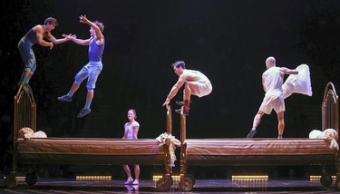 A mass trampoline slumber party somehow gives the impression of scampering up invisible walls, during Cirque du Soleil's opening night performance of Corteo in Montreal Dec. 19, 2018.