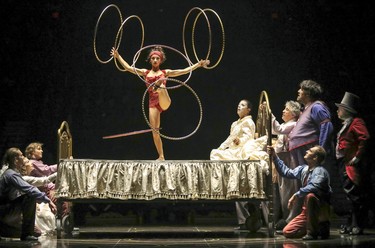 An acrobat spins hoops on Mauro's deathbed during opening night performance of Cirque du Soleil's Corteo in Montreal Dec. 19, 2018.