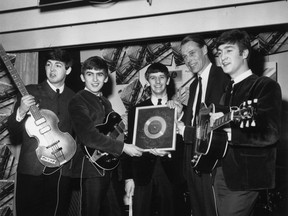 FILE: Beatles Producer George Martin Dies At 90 8th April 1963:  British pop group The Beatles holding their silver disc. Left to right are, Paul McCartney, George Harrison (1943 - 2001), Ringo Starr, George Martin of EMI and John Lennon (1940 - 1980).