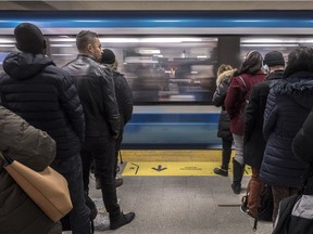 Montrealers politely line up to use the orange line at the Berri métro station in Montreal on Monday November 26, 2018.