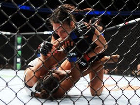 Montreal's Valérie Létourneau, top, fights Viviane Pereira of Brazil during the UFC 206 on Dec. 10, 2016, in Toronto.