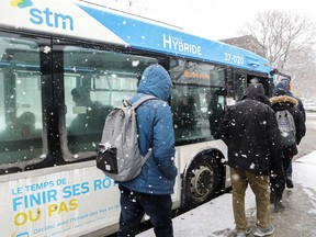 Passengers board a hybrid bus at Vendôme métro station in Montreal on Nov. 27, 2018.