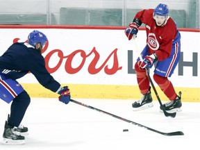 Nikita Scherbak, right, makes a pass past Jordie Benn during Montreal Canadiens training camp practice at the Bell Sports Complex in Brossard on Sept. 19, 2018.
