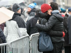 People hug each others as they attend a gathering around a makeshift memorial at Place Kleber, in Strasbourg, on December 16, 2018 to pay a tribute to the victims of Strasbourg's attack.