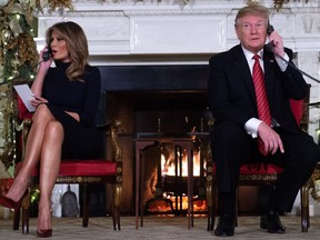 U.S. President Donald Trump and First Lady Melania Trump talk to people calling into the NORAD Santa tracker phone line Dec. 24, 2018.