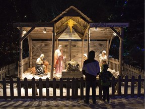 People pause to look at a Nativity scene on Saturday December 8, 2018 at the 60th annual Christmas Panorama at Wellington Park in Simcoe, Ontario.